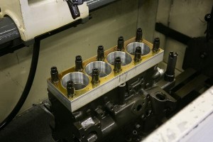 close-up-engine-block-in-sunnen-hone-machine